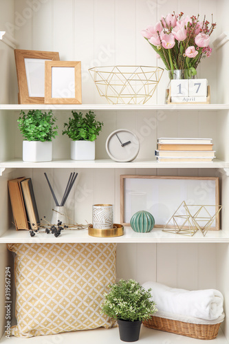 White shelving unit with plants and different decorative stuff © New Africa
