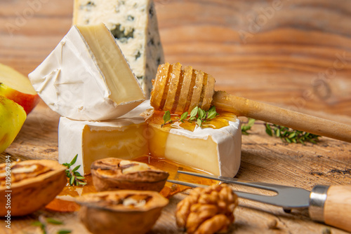 cheese and honey on old wooden table