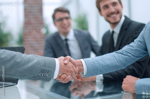 business handshake on the background of applauding business team