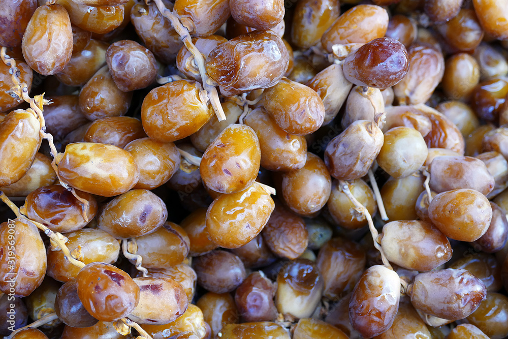 a large amount of fresh fresh dates, palm fruit sold in the shop, a large amount of fresh fresh dates, palm fruit sold in the shop,