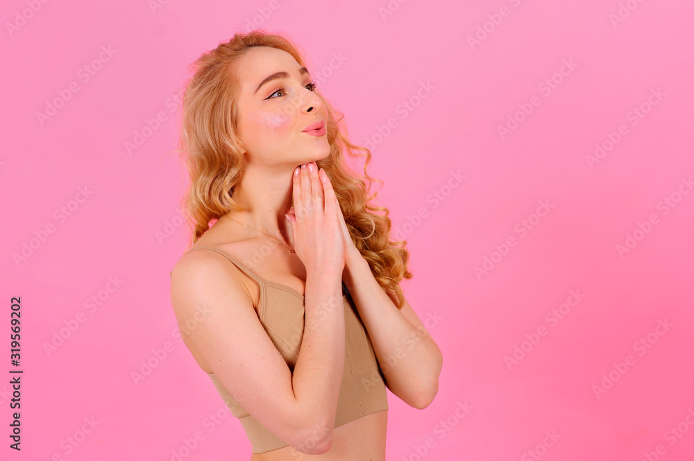 Gorgeous young blonde posing on a bright background Gorgeous young blonde posing on a bright background