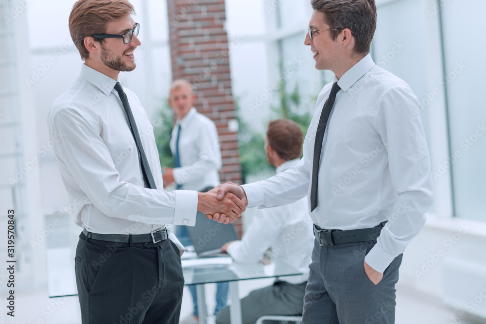close up. business colleagues shaking hands in the office. close up. business colleagues shaking hands in the office.