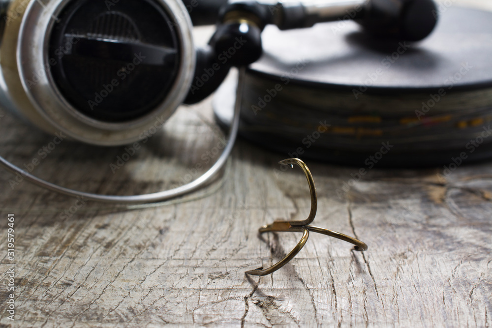 Preparing for the fishing season. Fishing hooks and other accessories on a wooden table. Preparing for the fishing season. Fishing hooks and other accessories on a wooden table.