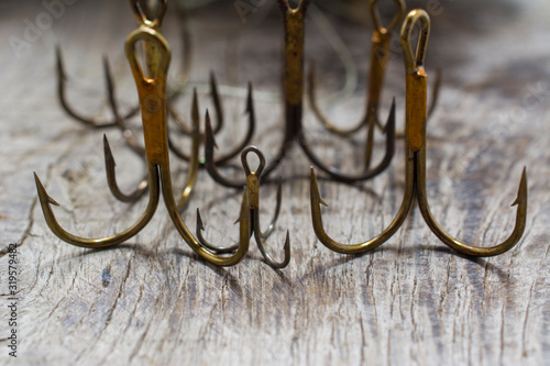 Preparing for the fishing season. Fishing hooks and other accessories on a wooden table.