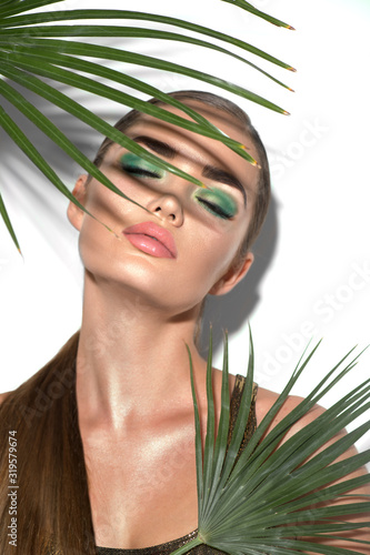 Stampa su tela Beauty Woman with natural green palm leaf Portrait, model girl with perfect makeup, green eyeshadows