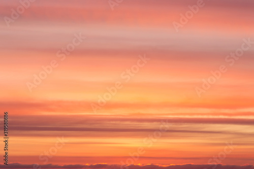 Dramatic soft sunrise, sunset orange yellow red sky with clouds background texture © Viktor Iden