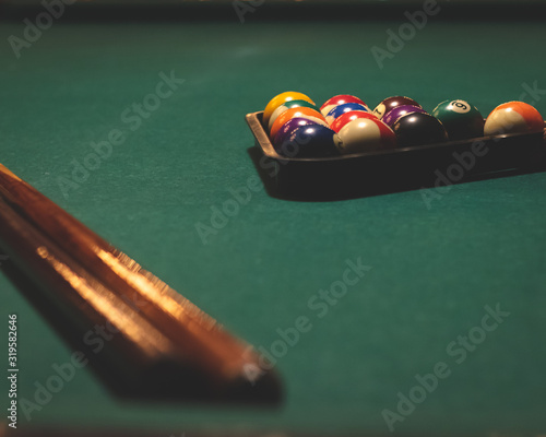 billiard table with balls and cue