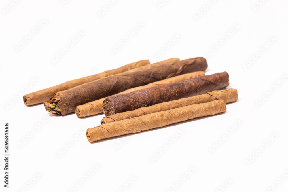 Close up Cuban cigarillo and cigars on white background. Close up Cuban cigarillo and cigars on white background.