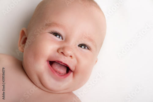 Happy baby laughing white background - copy space 