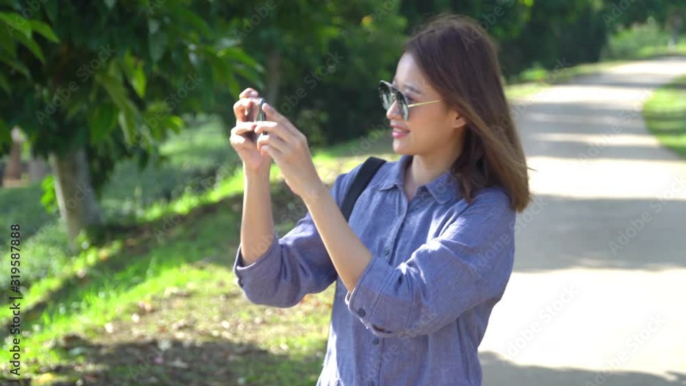 4k Young beautiful happy Asian woman walking through tea plantation and using smartphone taking a photo of nature in spring summer. Cheerful Asian woman relaxing and enjoying outdoor life in nature. 4k Young beautiful happy Asian woman walking through tea plantation and using smartphone taking a photo of nature in spring summer. Cheerful Asian woman relaxing and enjoying outdoor life in nature.