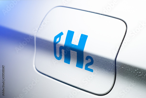 Car with hydrogen logo on filler cap. h2 combustion engine for emission free ecofriendly transport. photo