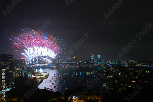 Colorful fireworks at Sydney Harbour Bridge for New Year celebration.