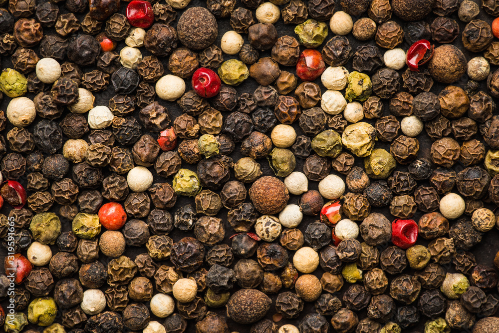 Mixed peppercorns on the rustic background. Selective focus. Shallow depth of field. Mixed peppercorns on the rustic background. Selective focus. Shallow depth of field.