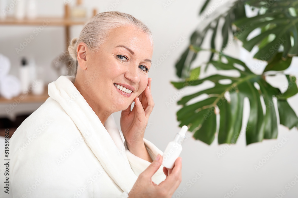 Beautiful mature woman with face serum at home Beautiful mature woman with face serum at home