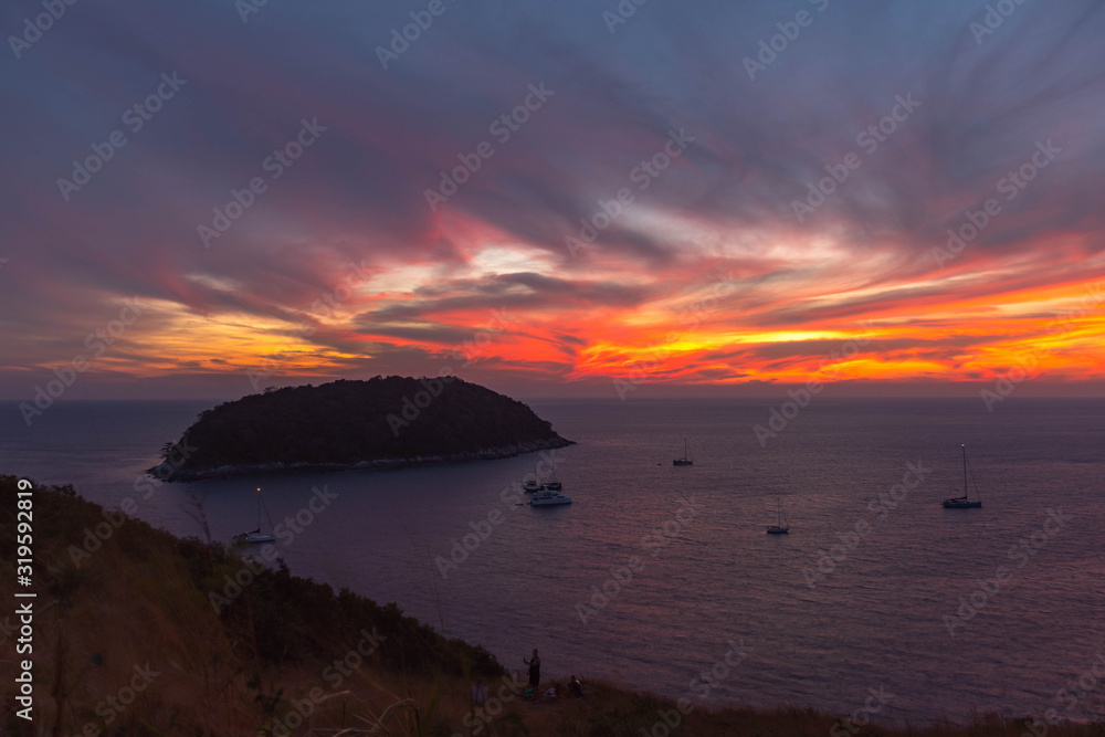 stunning sunset above Man island in front of Promthep cape and wind turbine viewpoint. .Promthep cape and wind turbine viewpoint are popular landmark in Phuket .