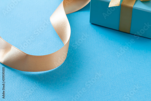 青いギフトボックスと金色のリボンのプレゼントのイメージ