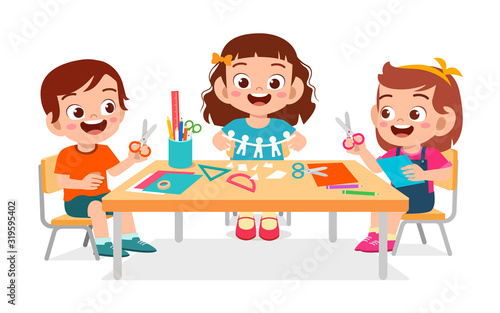 happy cute little kids boy and girl make paper craft