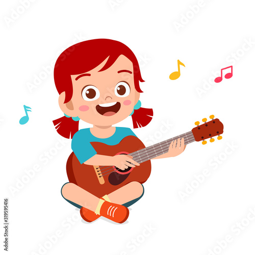 happy cute little kid girl play guitar