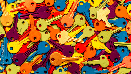 A whole bunch of colored keys on white background. Various colors. Close up background.