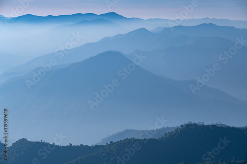 Mountain complex with misty or smoke pollution from wildfire during morning at the northern region of Thailand.