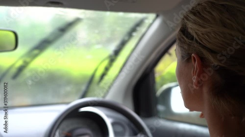 Wallpaper Mural Young woman driving a car during the rain, close up. Island of Zanzibar, Tanzania, East Africa, slow motion Torontodigital.ca
