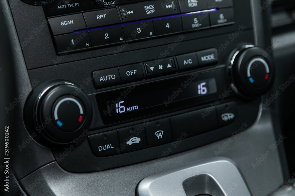 Obraz premium Close up Instrument automobile panel with climat control view with air conditioning buttons- details and controls of modern car..