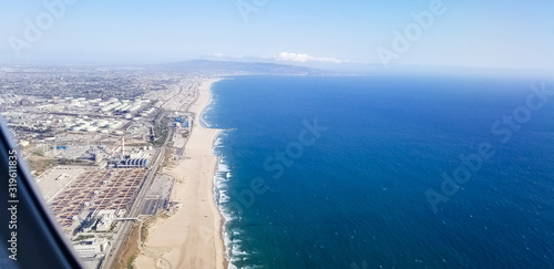 Aerial view from airplane of El Segundo oil refinery, power plants and coastline