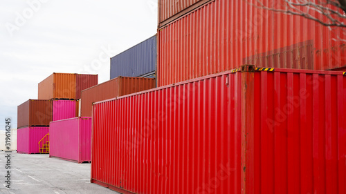 Open container yard with geometrically placed containers. warehouse container storage. goods delivery . bright multi-colored containers on a light background. heavy duty forklift