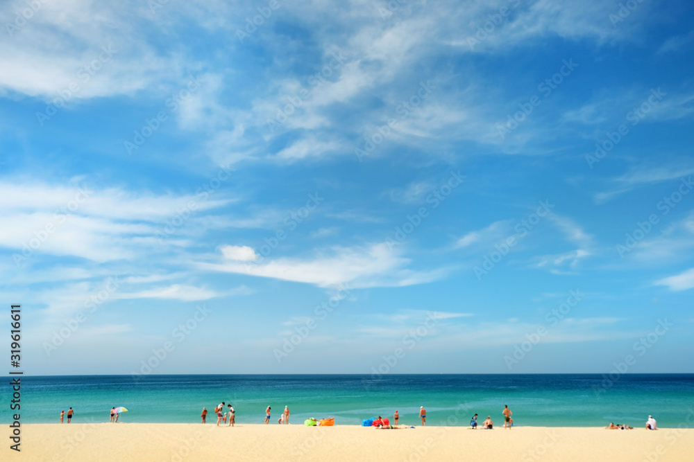 abstract background with sea, sandy beach and tourists. Summer travel, adventure and sea trip vacation concept. blurred background