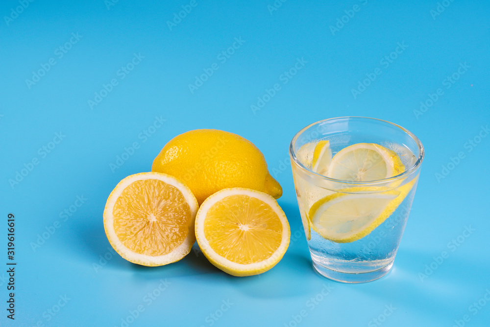 Lemonade with fresh lemons on blue background Lemonade with fresh lemons on blue background
