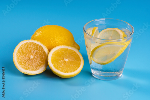 Lemonade with fresh lemons on blue background © mohdizuan