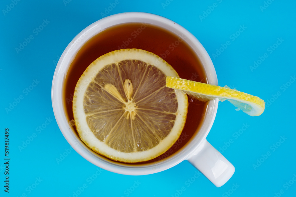 Top view, cup of a lemon tea over blue background. Top view, cup of a lemon tea over blue background.