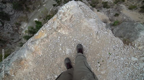 Crazy man walking towards the cliff. Extreme high rocky abyss. Point of view pov camera. A very dangerous madness. Ideal for suicide attempt, overcome fear, phobia threatening panic attack threat hike