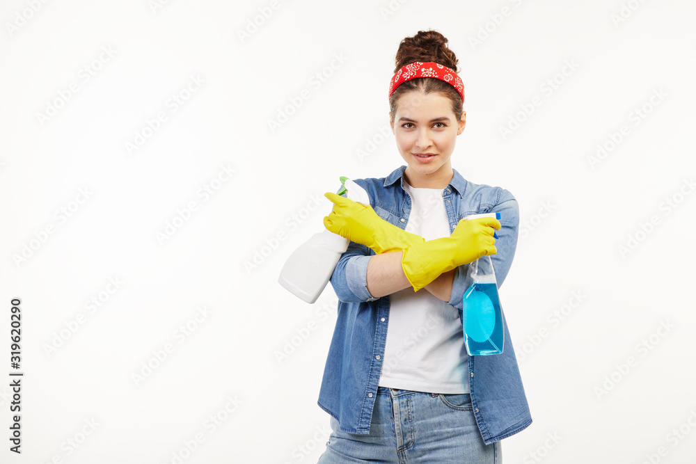 Pretty woman in work-wear uses window cleaning supplies. Pretty woman in work-wear uses window cleaning supplies.