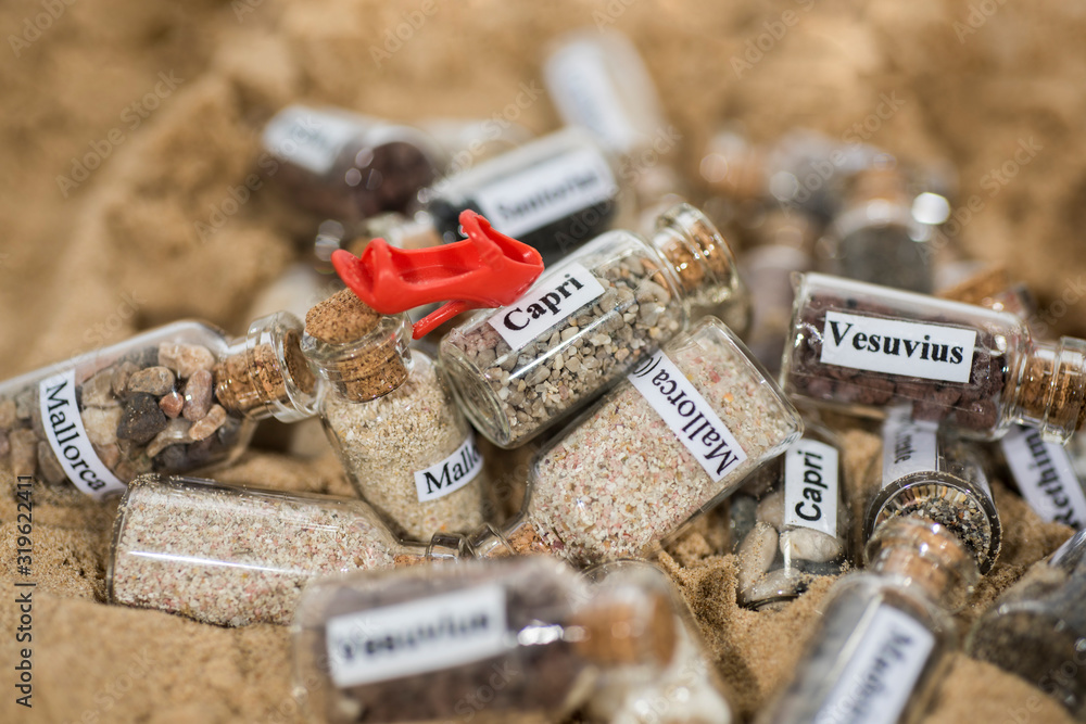 Glass test-tube with sand of different summer vacation destinations. Vacation time abstract photo. Glass test-tube with sand of different summer vacation destinations. Vacation time abstract photo.