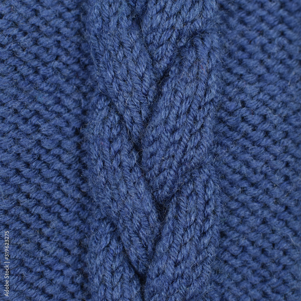 Needlework, hobbies, knitting. Background textile fabric with a knitted texture wool blue. Knitted pattern as background.