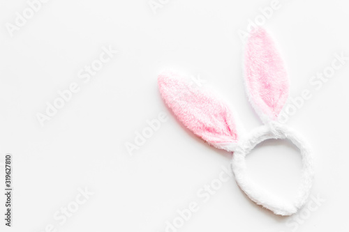 Easter bunny concept. Toy rabbit's ears for head on white background top-down copy space