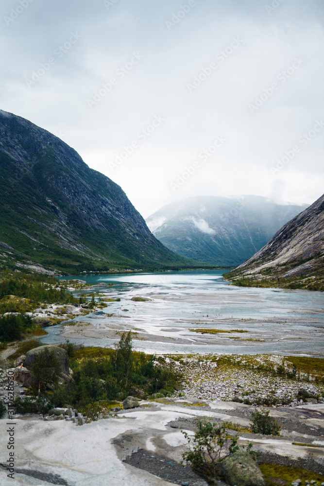 Picturesque landscape mountains of Norway. Beautiful view of the lake. Rocky shore of mountain lake in the morning. Travelling, lifestyle, wild nature concept.