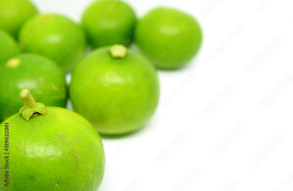 Closeup vibrant green limes on white background with copy space Closeup vibrant green limes on white background with copy space