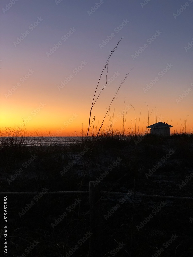 silhouette of fisherman at sunset