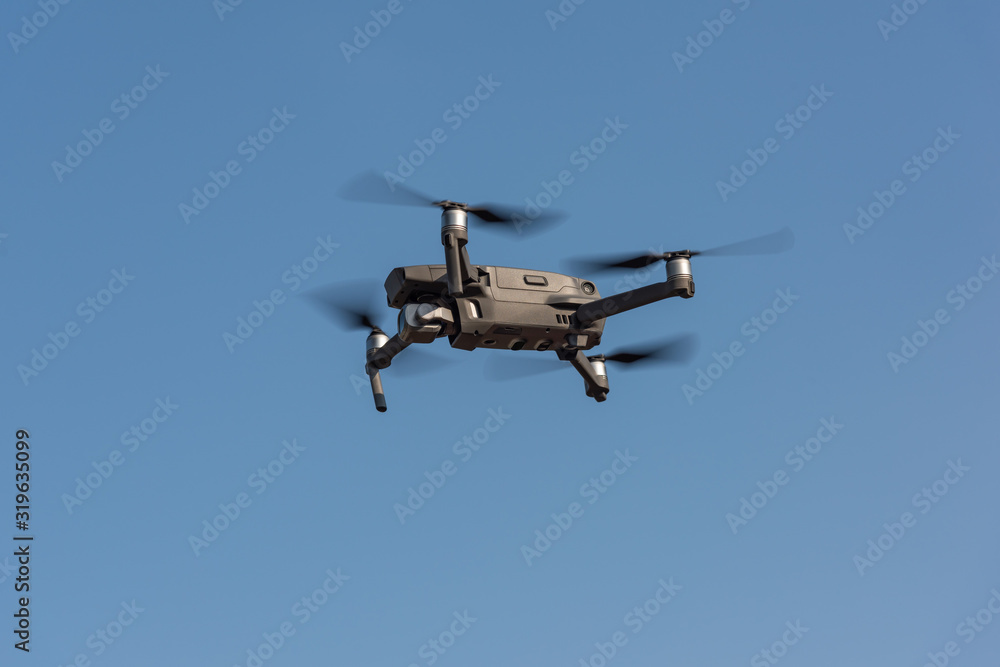 Small gray drone flying in the air Small gray drone flying in the air