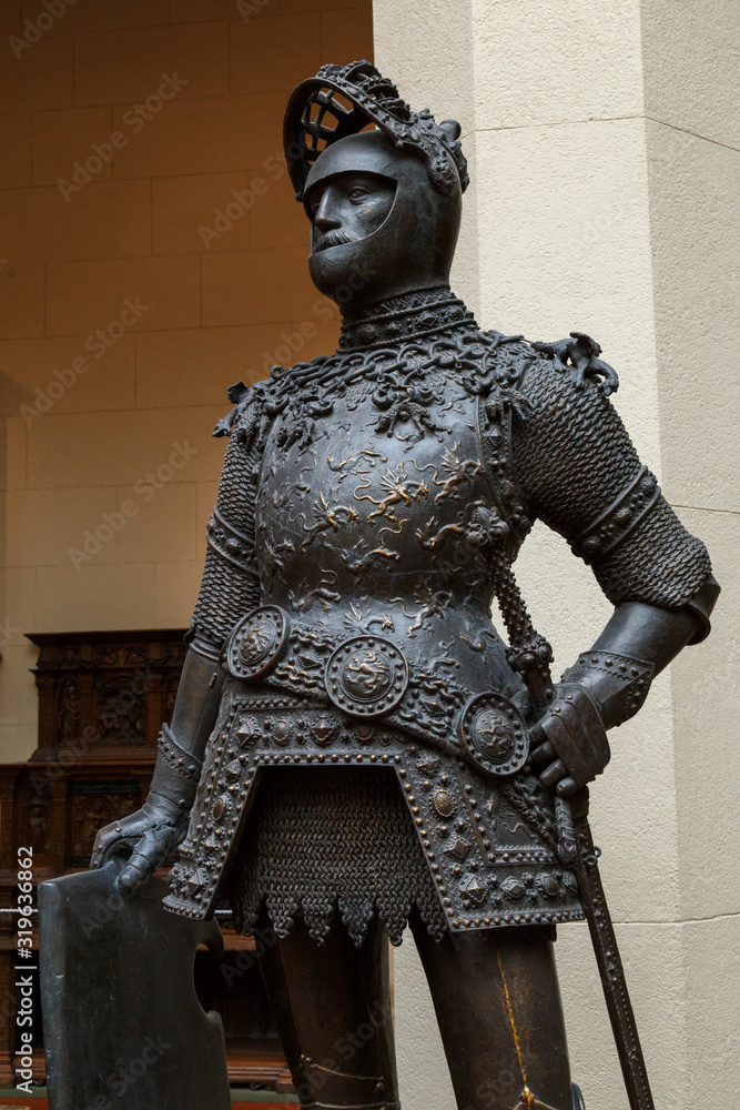 Sculpture of King Arthur old metal statue. Medieval knights armor full size standing warrior