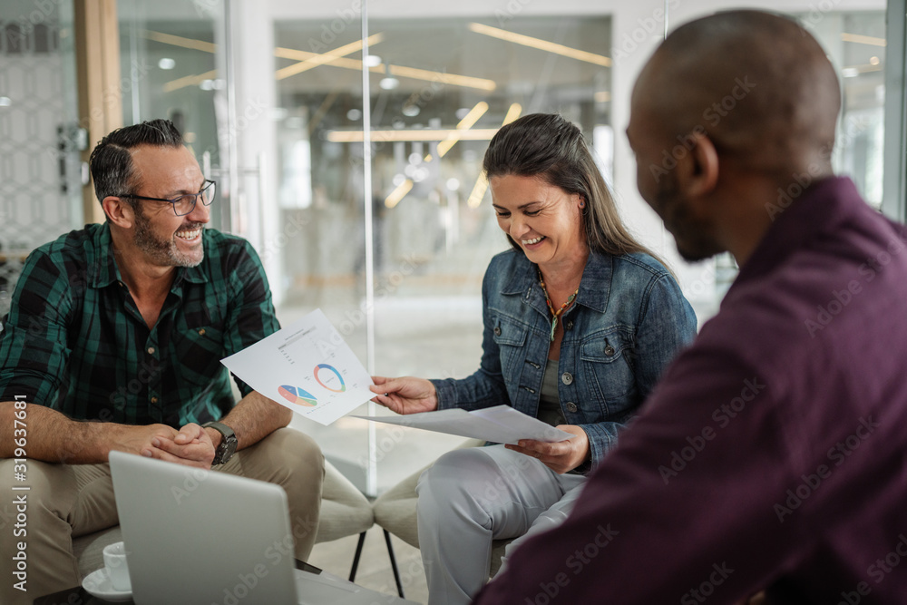 Happy smiling successful business colleagues having a candid seated casual meeting Happy smiling successful business colleagues having a candid seated casual meeting