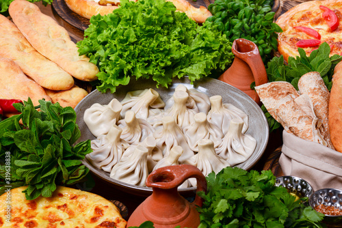 Top view of traditional Georgian cuisine: Kolkh and Adjara khachapuri, khinkali dumplings, shotis puri, kubdari or kubed photo