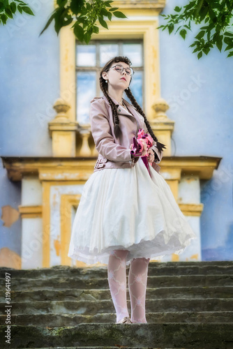 girl with a pink rifle stands on steps of stairs © Grigoriy Lukyanov