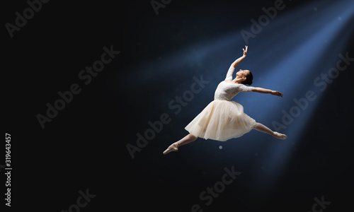 Ballet dancer in jump . Mix...