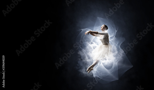 Ballet dancer in jump . Mix...