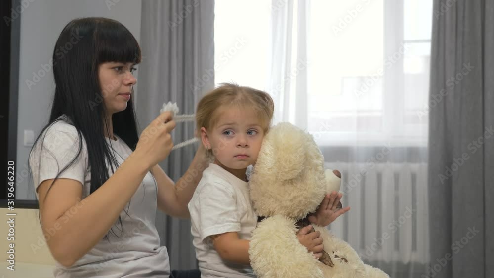 Happy family mother and daughter play with dolls, soft toys. Happy family mother and daughter play with dolls, soft toys.