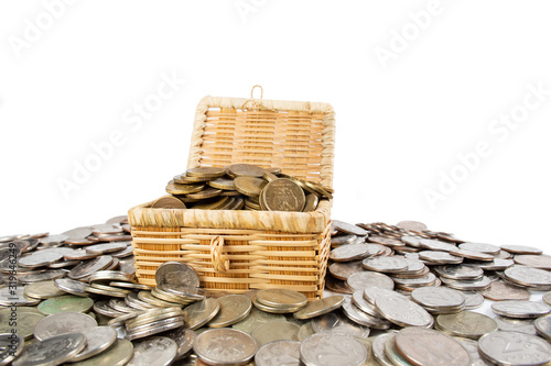 A treasure of money coins lies in and around the chest.