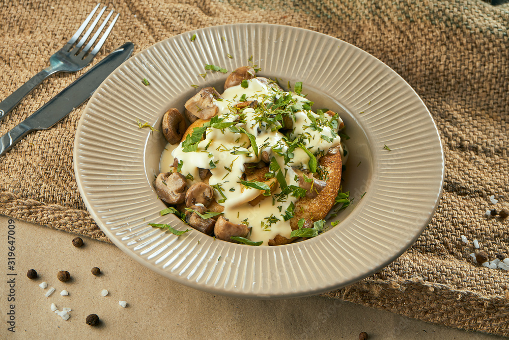 Close up view on tasty French crepes stuffed with chicken and mushrooms with sour cream in a beige ceramic plate. Food flat lay Close up view on tasty French crepes stuffed with chicken and mushrooms with sour cream in a beige ceramic plate. Food flat lay